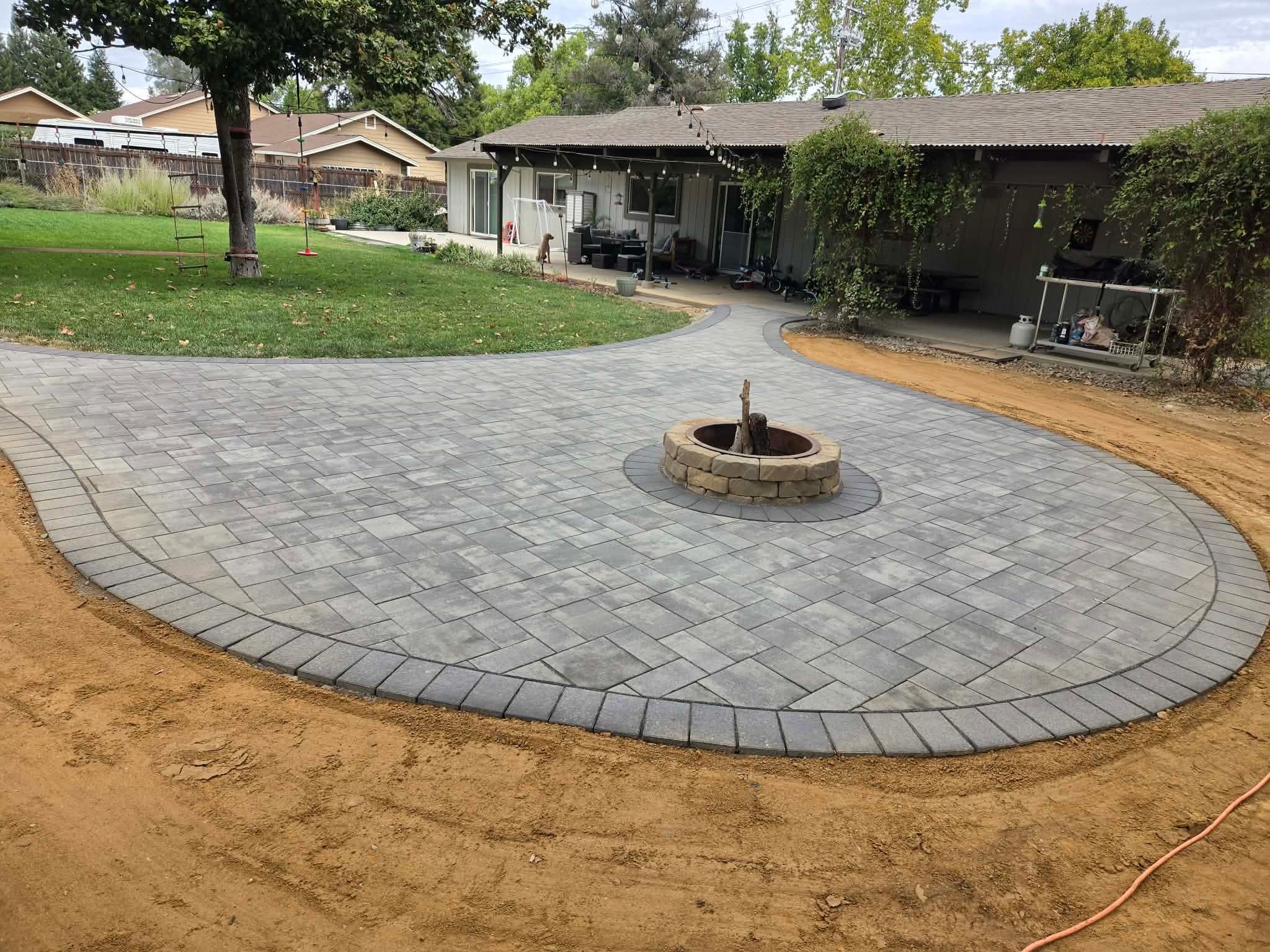 Premier Smooth paver patio in Torino color with a circular fire pit