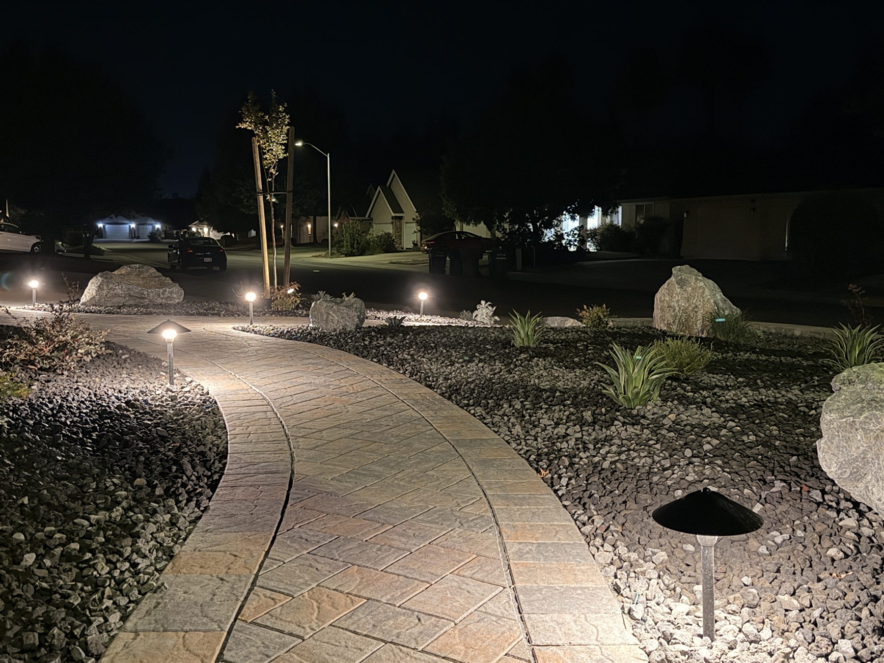 Low-voltage lights illuminating a curved paver path