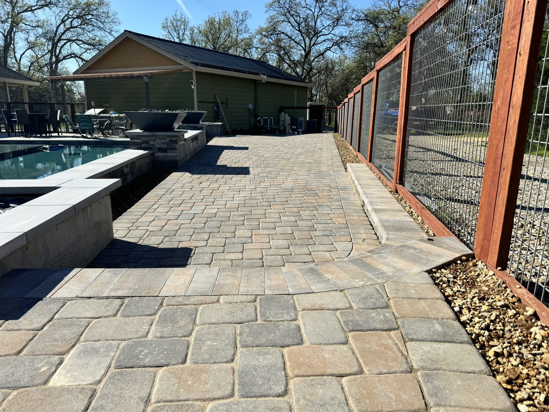 Paver walkway beside a retaining wall