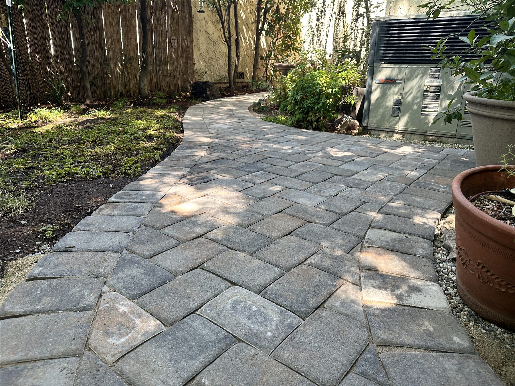 Finished paver patio in a shaded backyard